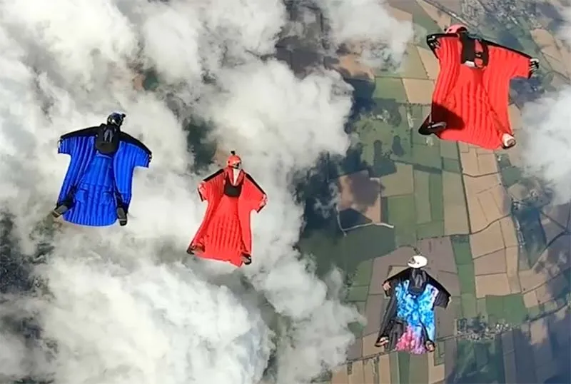 Wingsuit flock cruises above the clouds